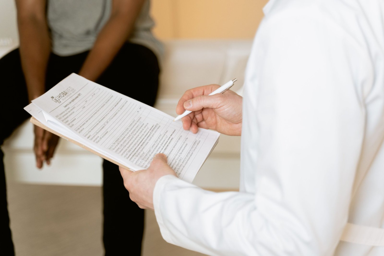 Healthcare professional reviewing a patient health screening form during a corporate screening session