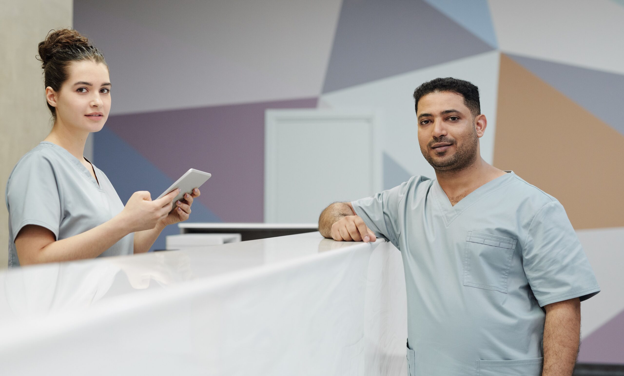 Clinic receptionist and practitioner at the front desk preparing for MediSave Chronic and Preventive Care claim changes
